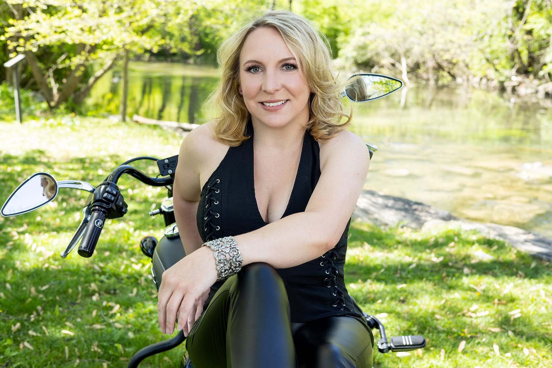 Woman poses on her motorcycle at her boudoir session with Shannon Hemauer Photography, located near Harrisburg PA.